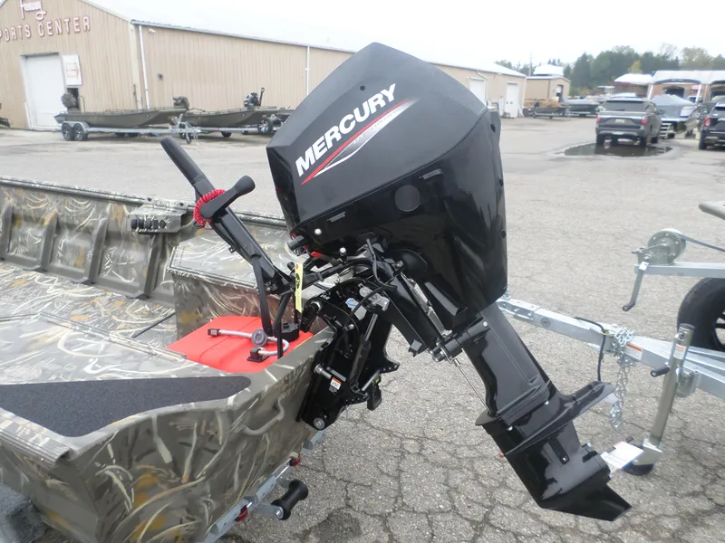 Slide: The Image of 2025 War Eagle 648 LDV boat with Mercury outboard motor in a sports center lot. - 3