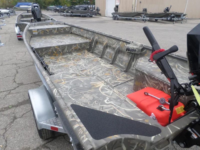 Slide: The Image of 2025 War Eagle 648 LDV boat with camouflage interior, parked on a trailer. - 4