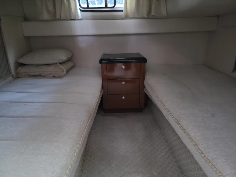 Slide: The Image of Interior cabin of 2002 Monterey 322 Cruiser with twin beds and central drawer unit. - 11