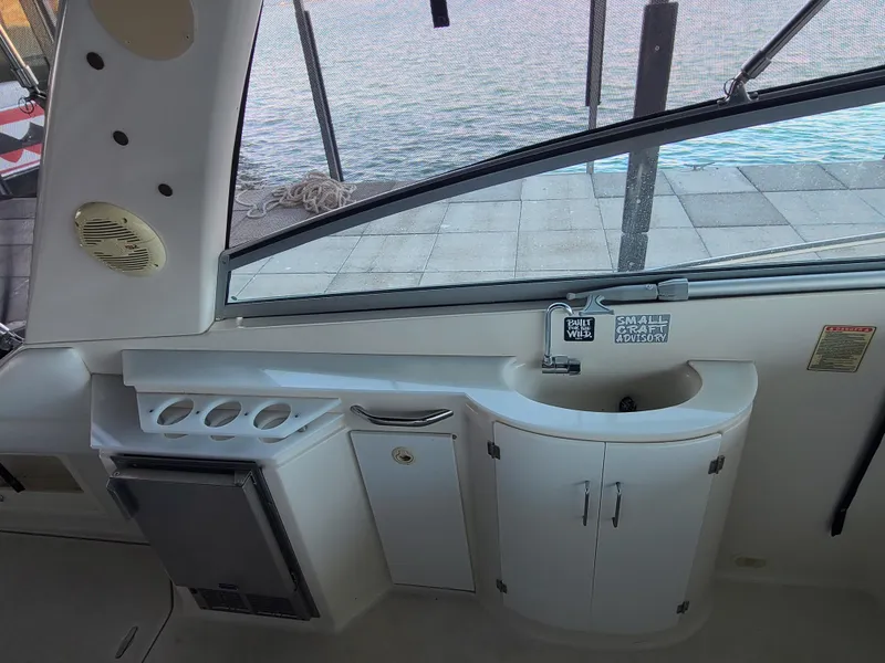Slide: The Image of Interior view of a 2002 Monterey 322 Cruiser boat with kitchenette and sink. - 12