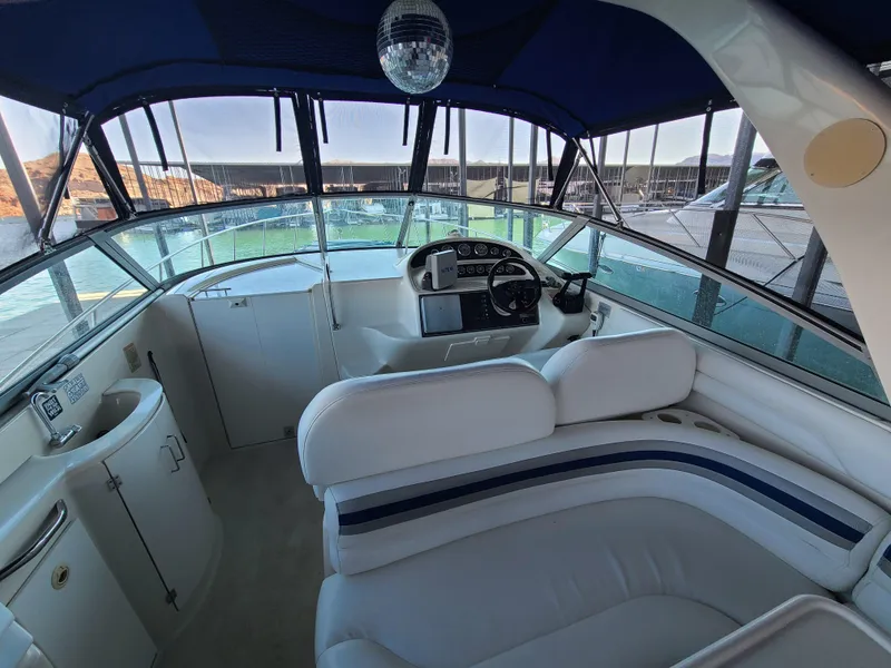 Slide: The Image of Interior of 2002 Monterey 322 Cruiser with white seating and modern dashboard. - 13