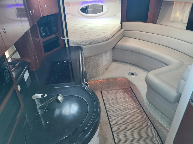 Slide: The Image of Interior of a 2002 Monterey 322 Cruiser with modern kitchen and cozy seating area. - 5