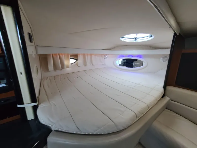 Slide: The Image of Interior cabin of 2002 Monterey 322 Cruiser with circular bed and porthole window. - 7
