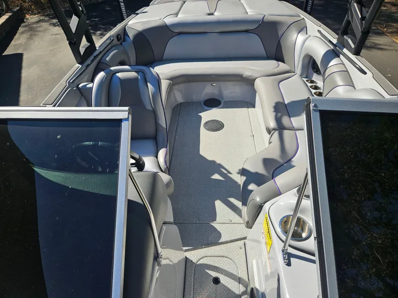 Slide: The Image of 2023 Sanger V215 LTZ boat interior with gray seating and open bow design. - 16