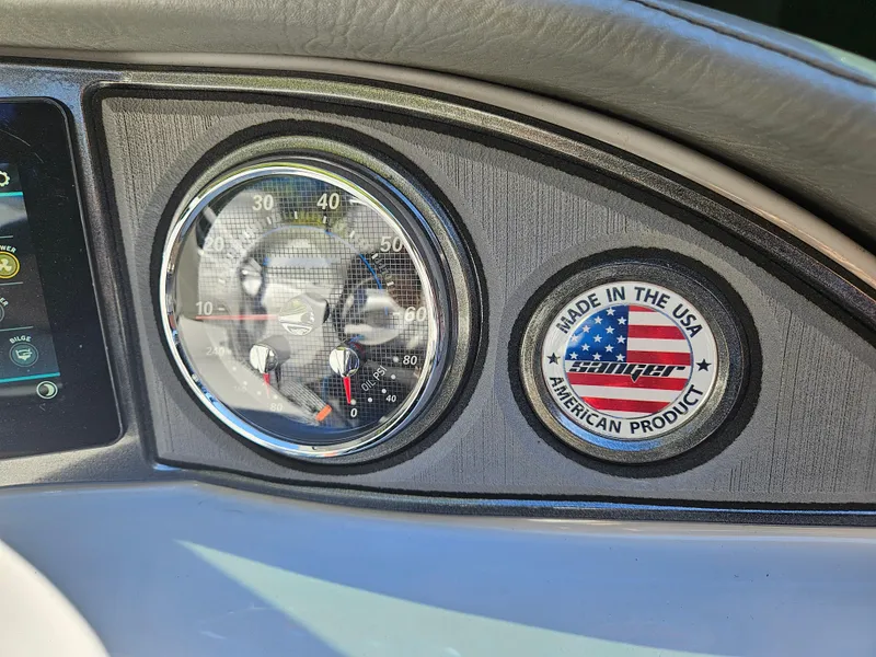 Slide: The Image of Dashboard of 2023 Sanger V215 LTZ boat with speedometer and "Made in the USA" badge. - 21