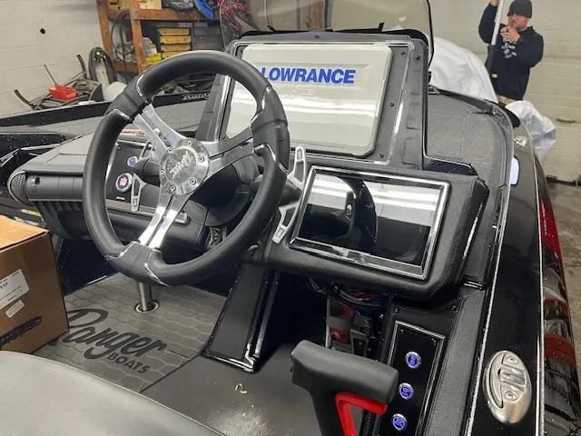 Slide: The Image of 2025 Ranger Z520R boat dashboard with Lowrance electronics and steering wheel. - 14