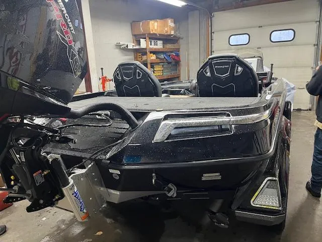 Slide: The Image of 2025 Ranger Z520R Ranger Cup boat in garage, rear view with motor and seats visible. - 15