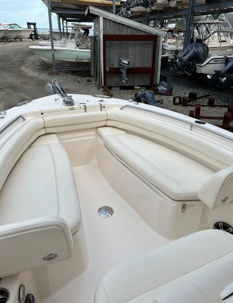 Slide: The Image of 2020 Grady-White 257 Fisherman boat interior with white seating and storage. - 11