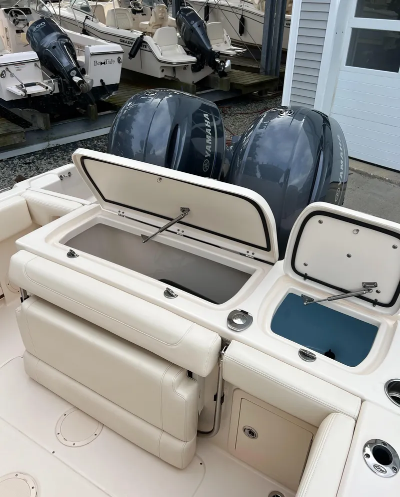 Slide: The Image of 2020 Grady-White 257 Fisherman boat with open storage compartments and dual Yamaha outboard engines. - 3