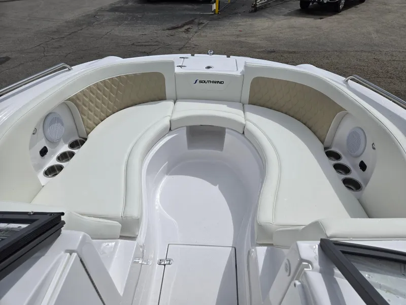 Slide: The Image of 2025 SouthWind 2200 SD boat interior with white seating and cup holders. - 12