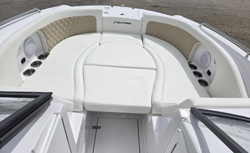 Slide: The Image of 2025 SouthWind 2200 SD boat interior with white cushioned seating and cup holders. - 14