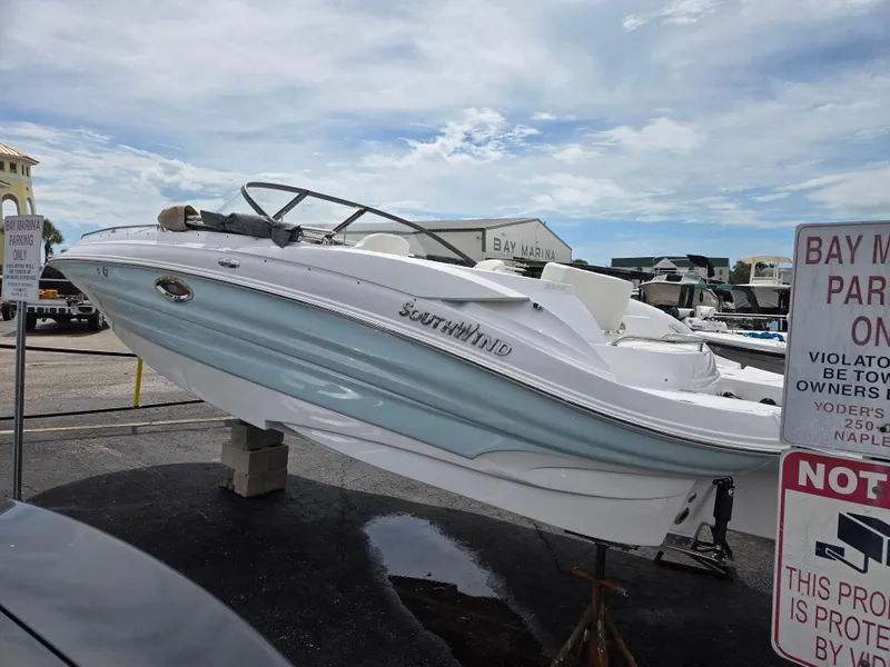Slide: The Image of 2025 SouthWind 2200 SD boat displayed on a stand at a marina. - 2