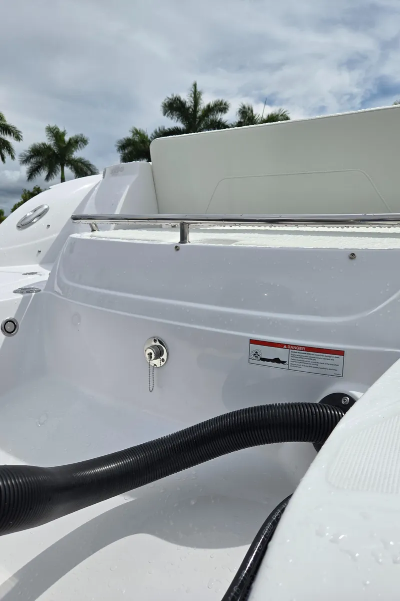 Slide: The Image of 2025 SouthWind 2200 SD boat interior with sleek white design and palm trees in background. - 22