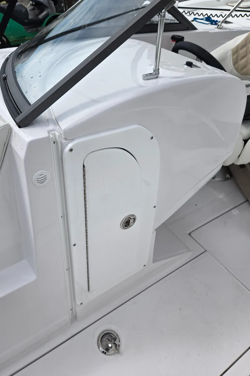 Slide: The Image of 2025 SouthWind 2200 SD boat cockpit with white seating and sleek design. - 24