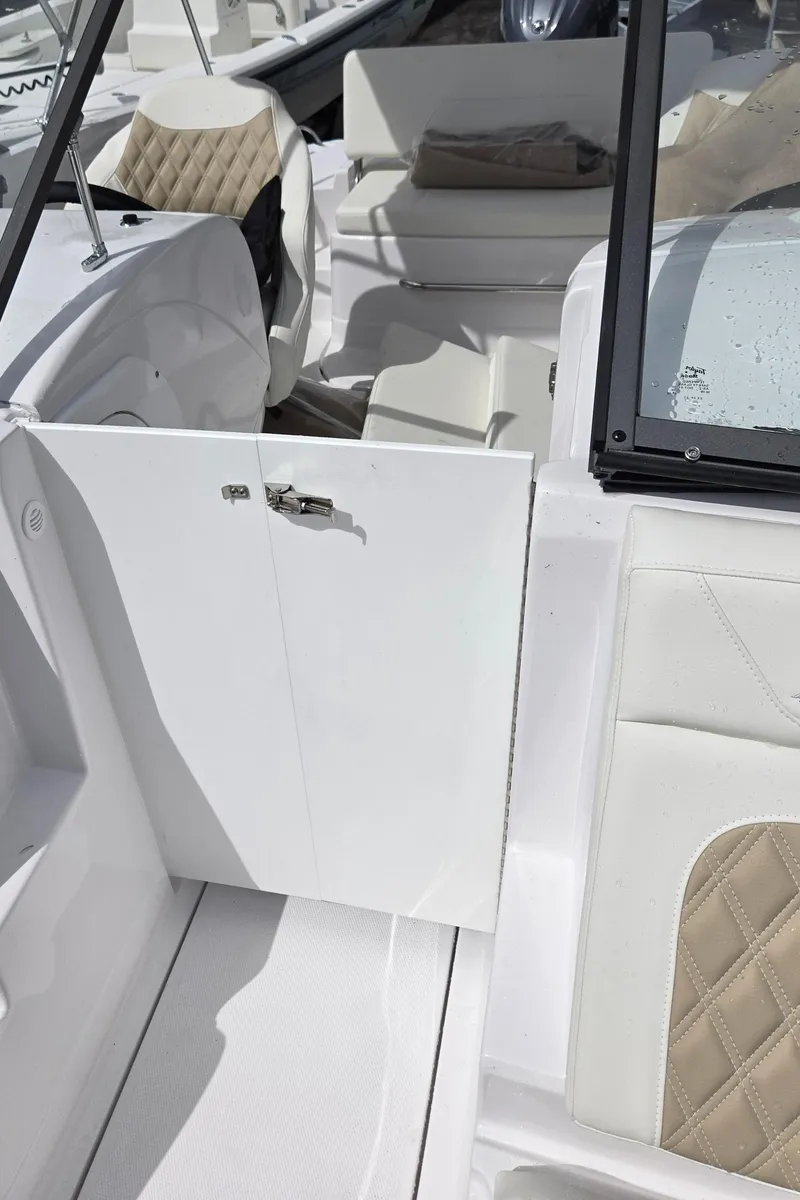 Slide: The Image of 2025 SouthWind 2200 SD boat interior with white and beige seating. - 26