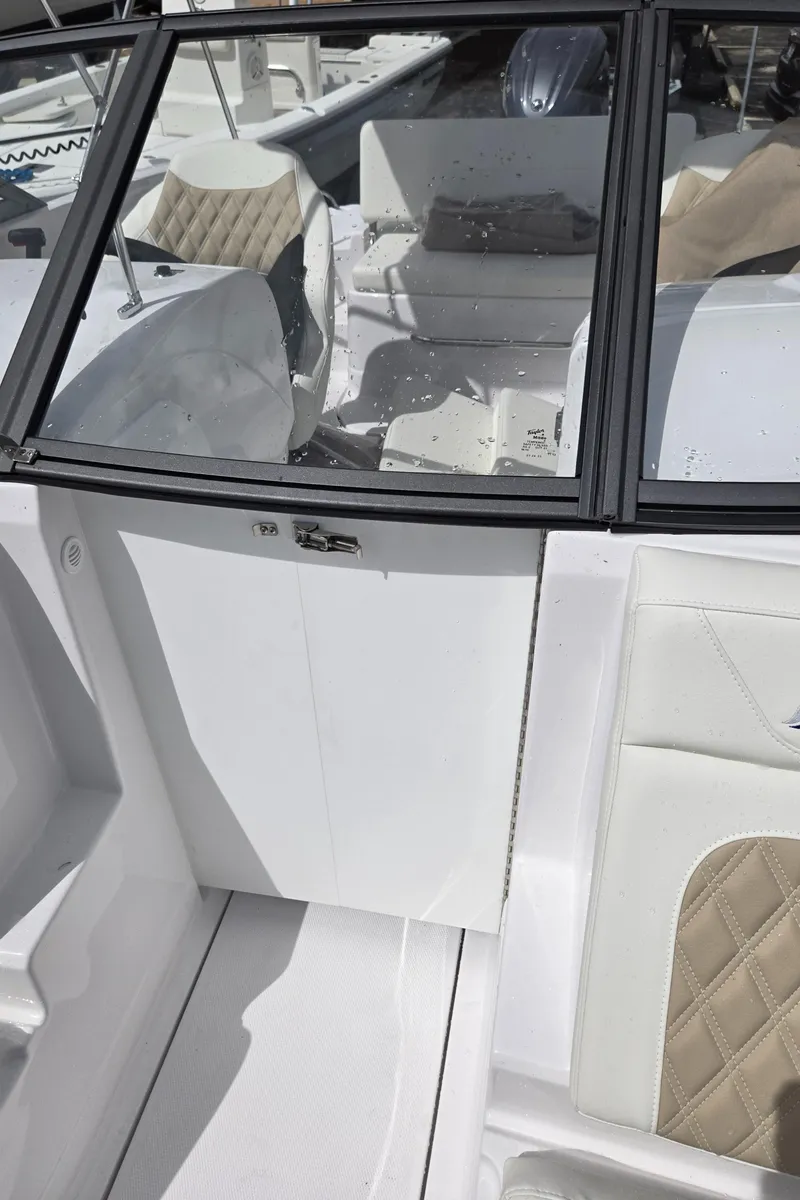 Slide: The Image of 2025 SouthWind 2200 SD boat interior with beige quilted seats and sleek design. - 27
