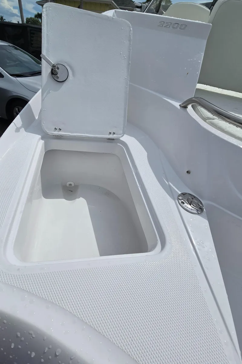 Slide: The Image of 2025 SouthWind 2200 SD boat storage compartment, open lid, white interior. - 28