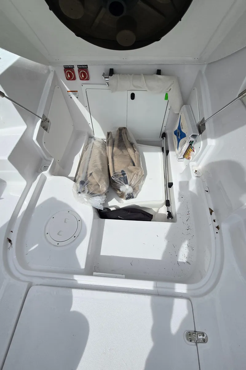Slide: The Image of 2025 SouthWind 2200 SD boat interior storage compartment with safety equipment. - 30