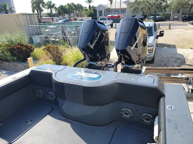 Slide: The Image of 2026 Shallow Sport 32 X3 boat with dual Mercury outboard engines, parked near a marina. - 15