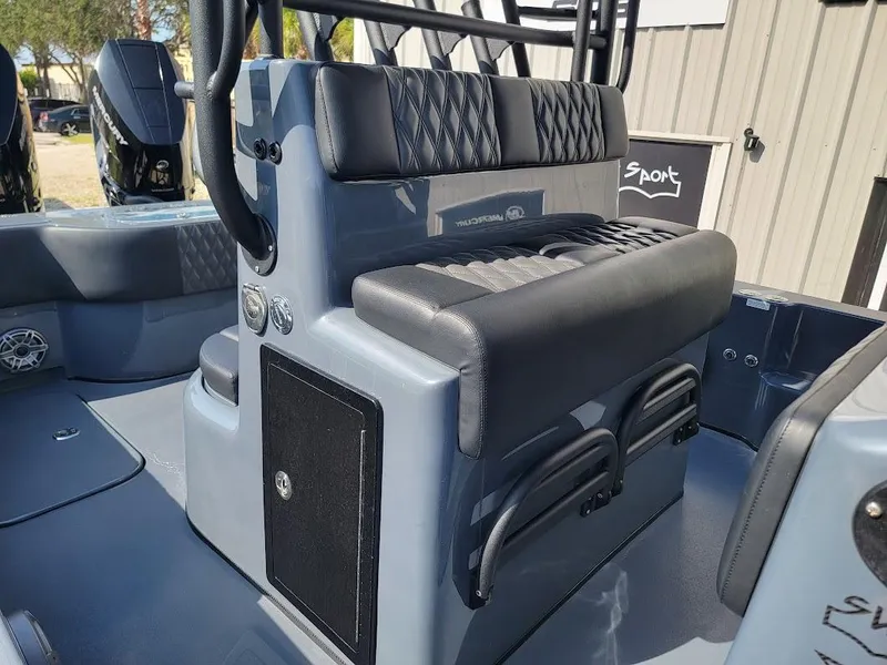 Slide: The Image of 2026 Shallow Sport 32 X3 boat interior with cushioned seating and storage compartments. - 18