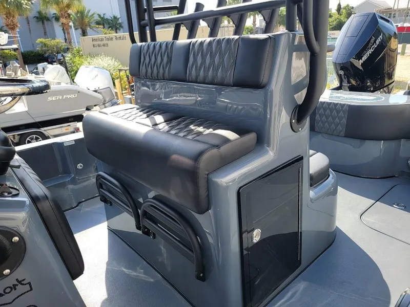Slide: The Image of 2026 Shallow Sport 32 X3 boat interior with cushioned seating and storage compartments. - 19
