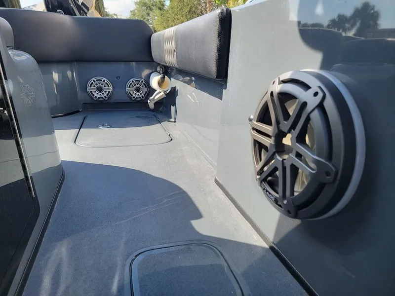 Slide: The Image of 2026 Shallow Sport 32 X3 boat interior with speakers and seating area. - 21