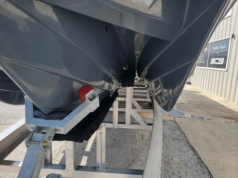 Slide: The Image of 2026 Shallow Sport 32 X3 boat hull on trailer, close-up view. - 3