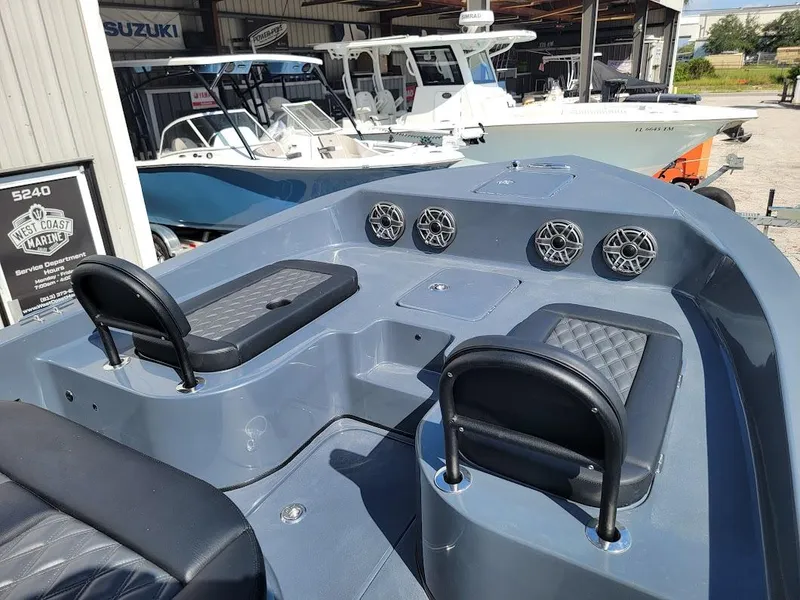 Slide: The Image of Shallow Sport 32 X3 2026 boat interior with seating and speakers in a marina setting. - 31