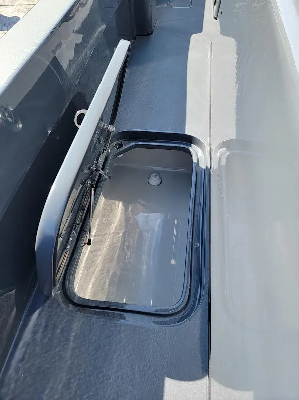 Slide: The Image of 2026 Shallow Sport 32 X3 boat storage compartment with open hatch. - 33