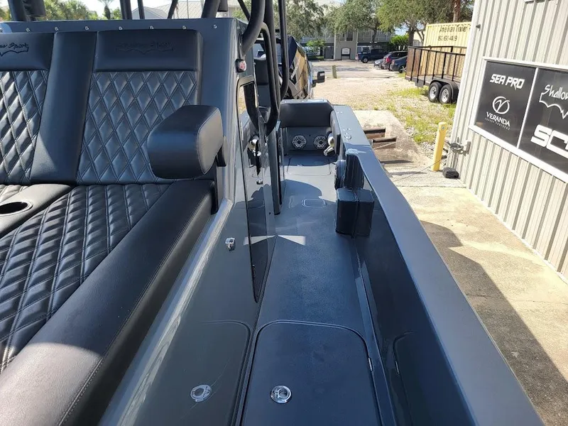 Slide: The Image of 2026 Shallow Sport 32 X3 boat interior with diamond-stitched seating and sleek design. - 35