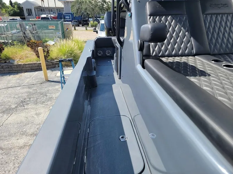 Slide: The Image of 2026 Shallow Sport 32 X3 boat interior with quilted seating and sleek design. - 36