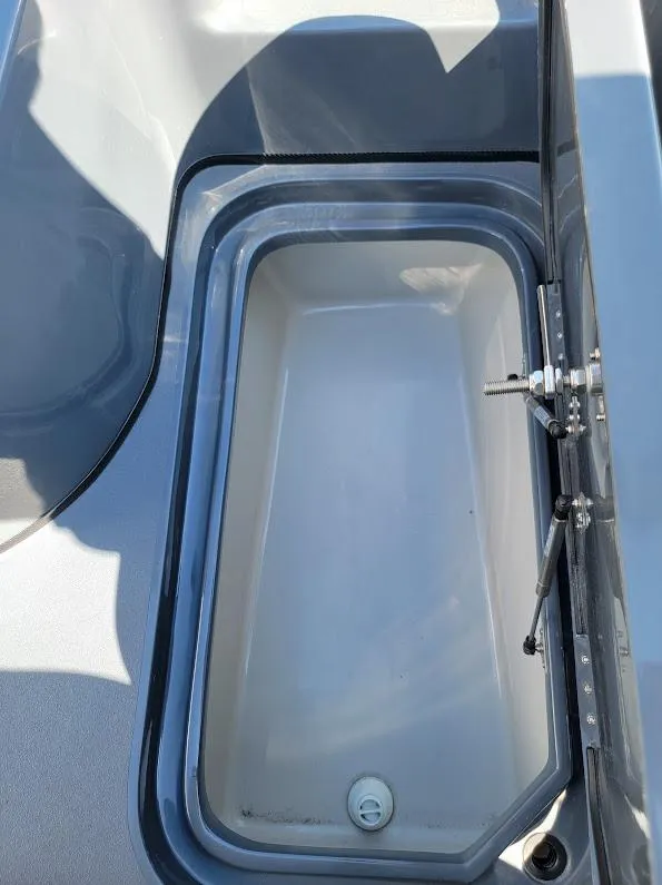 Slide: The Image of 2026 Shallow Sport 32 X3 boat storage compartment with open lid. - 43
