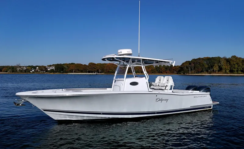 Slide: The Image of 2022 Southport 27 FE boat on calm water, clear sky background. - 0