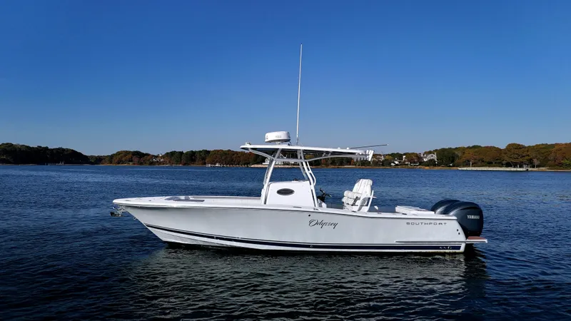 Slide: The Image of 2022 Southport 27 FE boat on calm water under clear blue sky. - 1