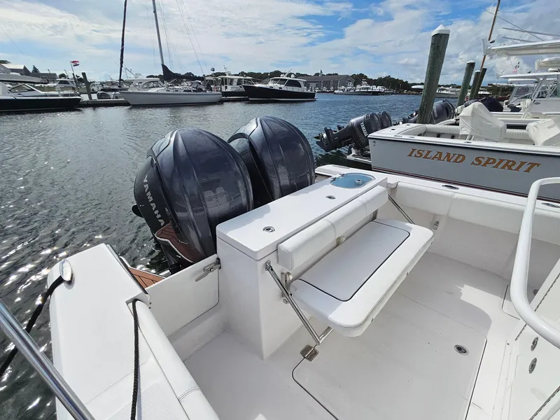 Slide: The Image of 2022 Southport 27 FE boat with dual outboard motors docked in marina. - 10