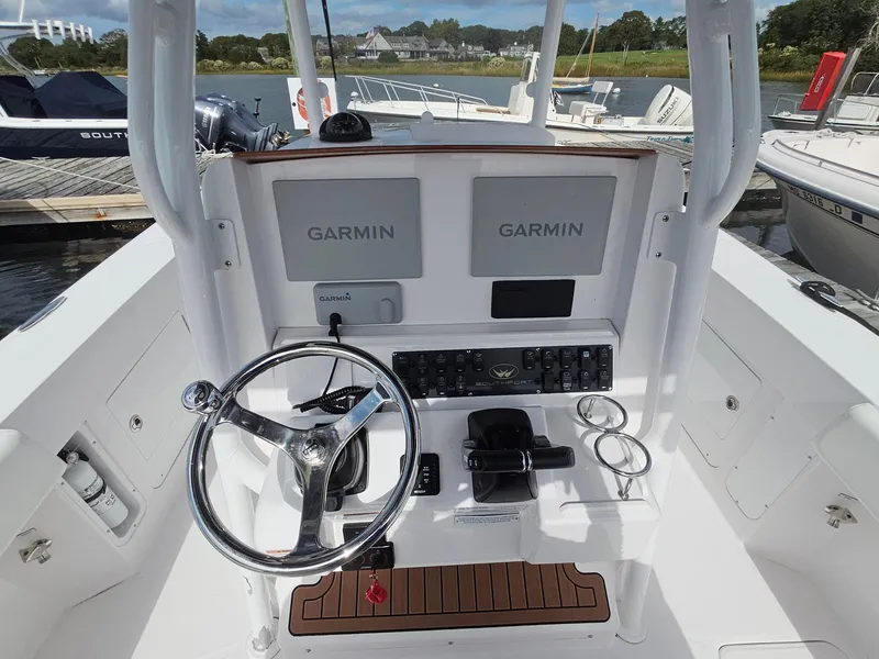 Slide: The Image of 2022 Southport 27 FE boat helm with dual Garmin displays and steering wheel. - 11