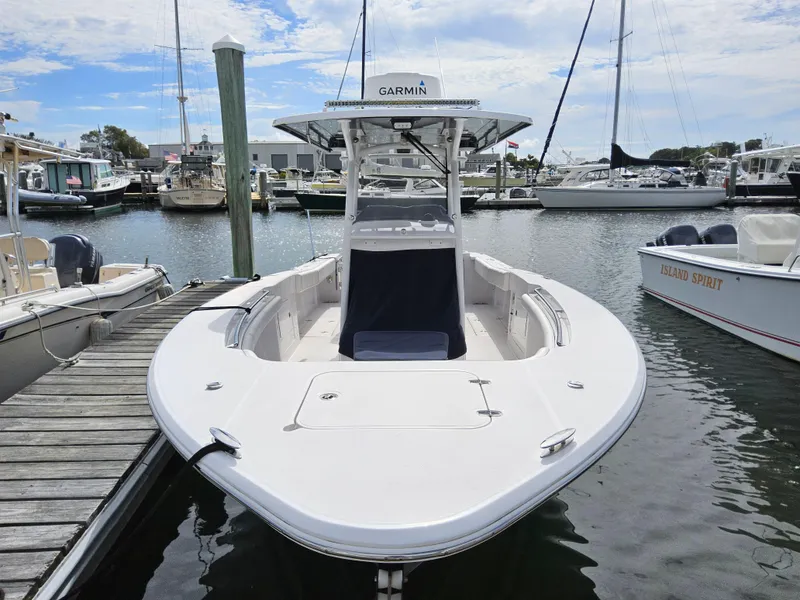 Slide: The Image of 2022 Southport 27 FE boat docked at marina, featuring Garmin equipment. - 4