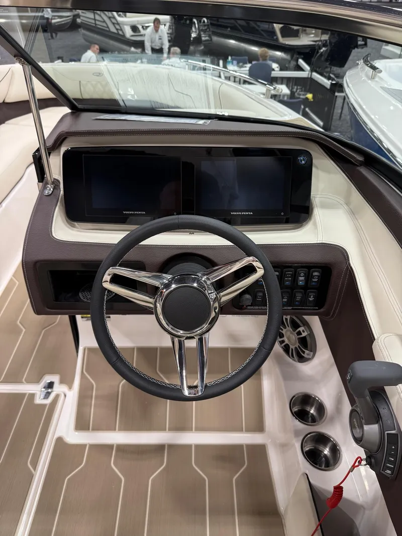 Slide: The Image of 2025 Regal LS4 boat dashboard with steering wheel and dual displays. - 12