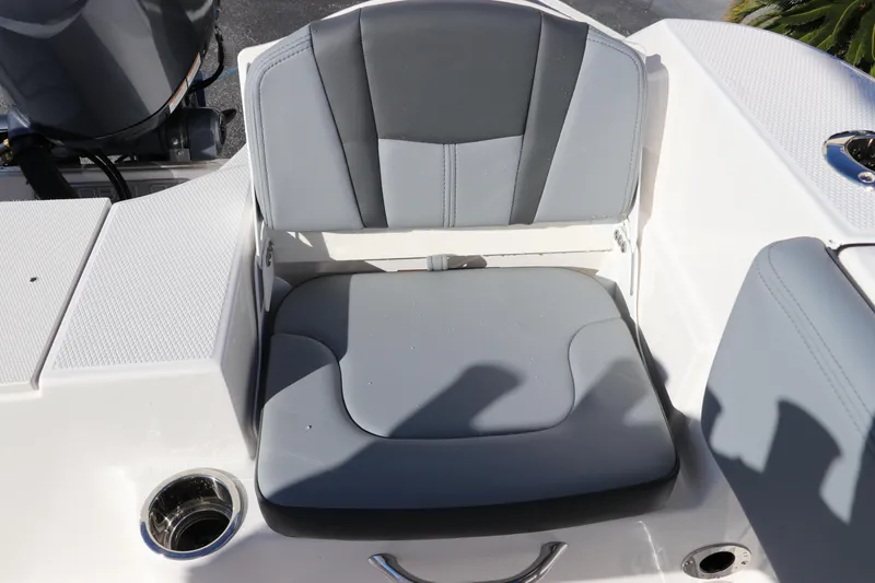 Slide: The Image of 2025 Robalo R200 Center Console boat seat with gray upholstery and cup holder. - 10
