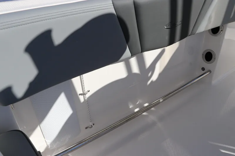 Slide: The Image of 2025 Robalo R200 Center Console interior detail with seating and stainless steel rail. - 13