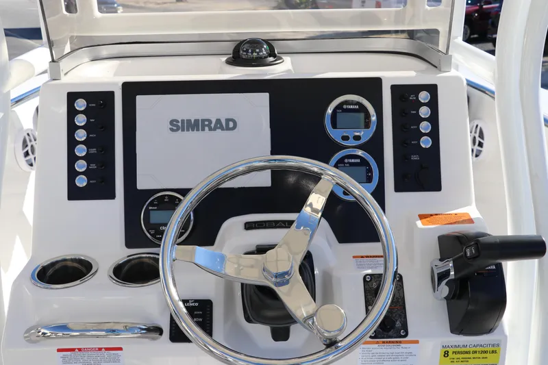 Slide: The Image of 2025 Robalo R200 Center Console dashboard with Simrad navigation system and steering wheel. - 19