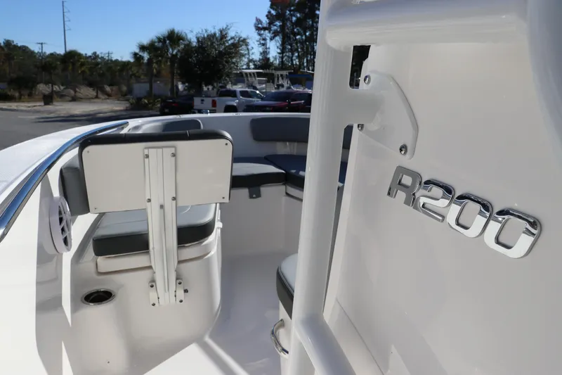 Slide: The Image of 2025 Robalo R200 Center Console boat interior with seating and logo detail. - 24