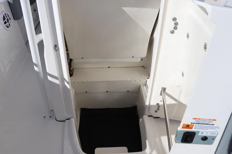 Slide: The Image of 2025 Robalo R200 Center Console interior storage compartment with open hatch. - 26