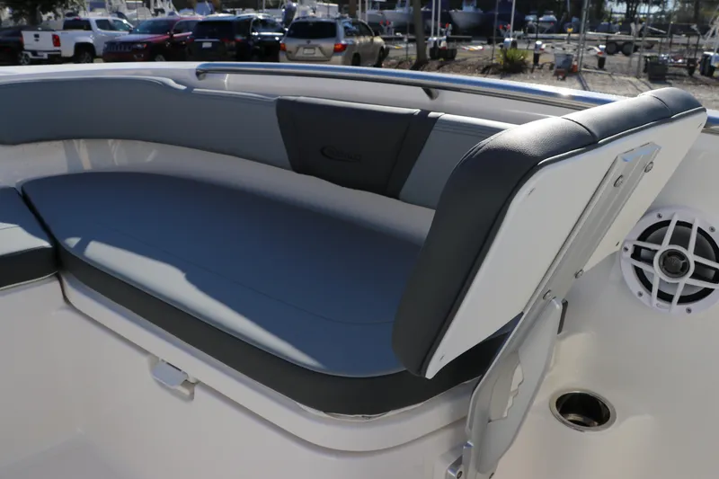 Slide: The Image of 2025 Robalo R200 Center Console boat seating area with cushioned bench and speaker. - 28
