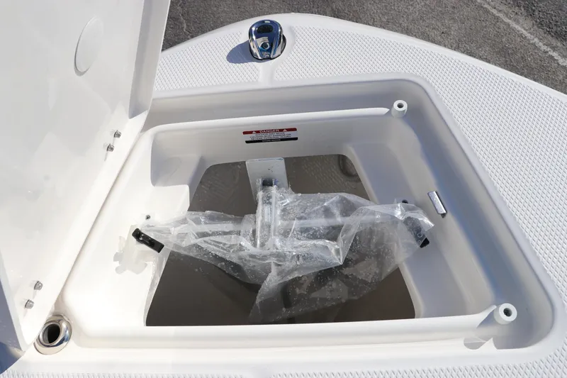 Slide: The Image of 2025 Robalo R200 Center Console anchor storage compartment with open lid. - 33