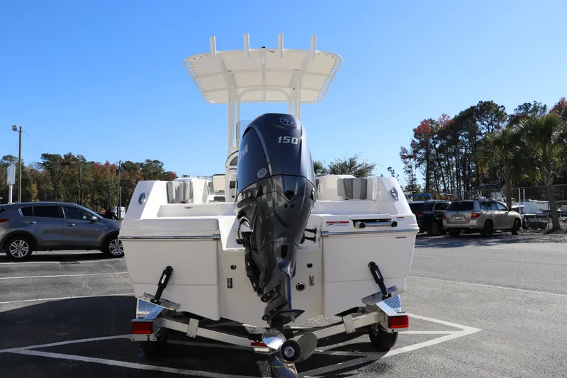 Slide: The Image of 2025 Robalo R200 Center Console boat with 150 HP engine in parking lot. - 6