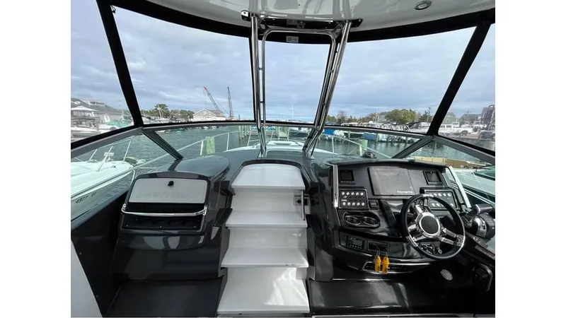 Slide: The Image of 2021 Monterey 335 Sport Yacht cockpit with modern controls and panoramic view. - 10