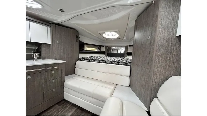 Slide: The Image of 2021 Monterey 335 Sport Yacht interior with modern design, featuring a cozy seating area and kitchenette. - 11
