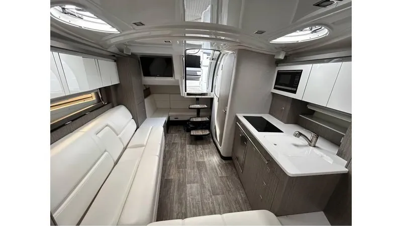 Slide: The Image of 2021 Monterey 335 Sport Yacht interior with modern kitchen and seating area. - 14