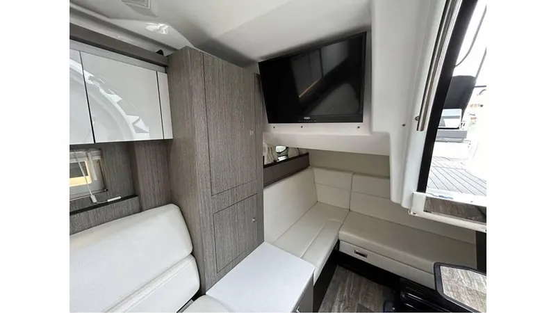 Slide: The Image of Interior of 2021 Monterey 335 Sport Yacht with modern seating and mounted TV. - 16
